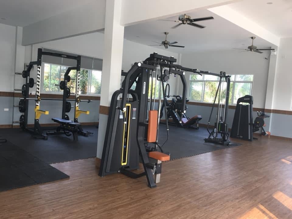 The weights room at Hamton Fitness & Pool, with squat racks and cable machines