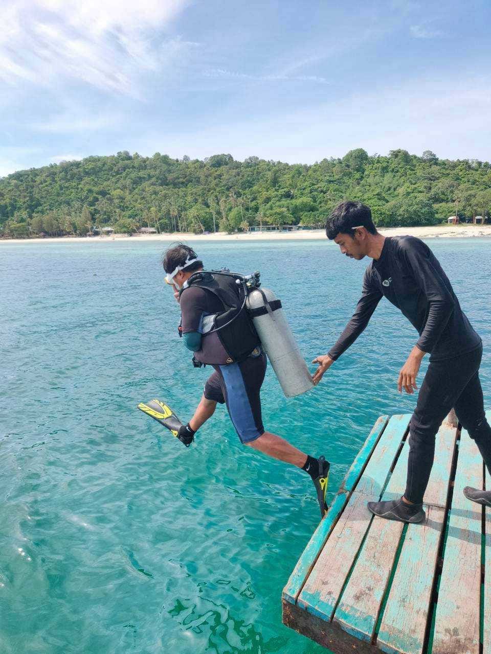 Scuba divers set off from the resort pier