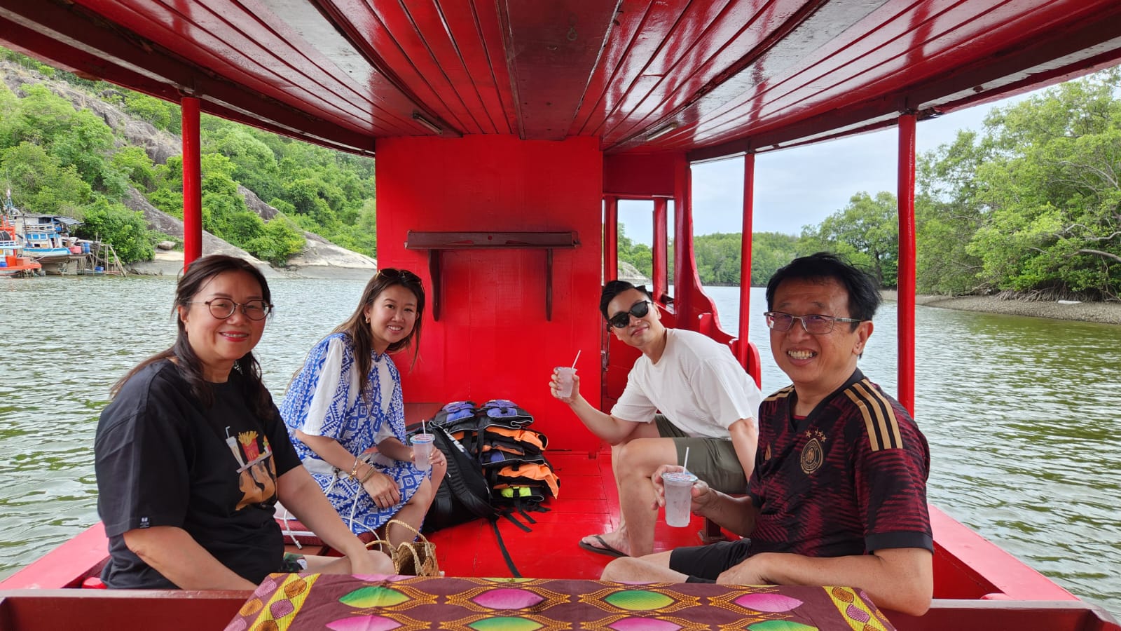 Gliding along the Pak Nam Pran river on a traditional wooden boat
